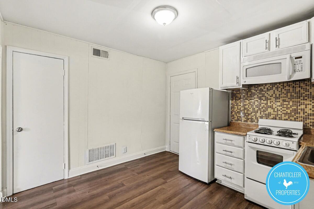 115 Florence Street, Unit 19 Graham, NC 27253 - Photo 3 of 29 a kitchen with white cabinets and white appliances