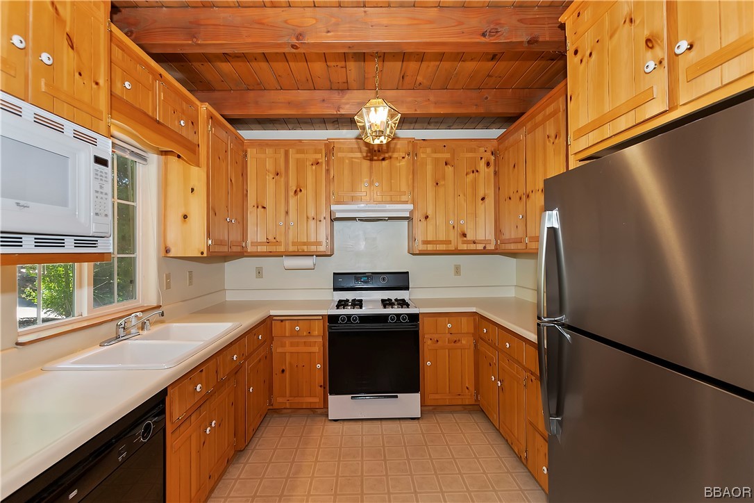 189 Pine Ridge Road Crestline, CA 92325 - Photo 11 of 30 a kitchen with stainless steel appliances a refrigerator sink and cabinets