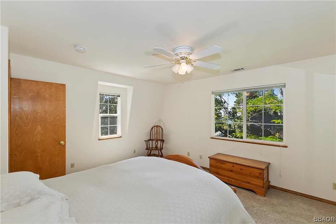189 Pine Ridge Road Crestline, CA 92325 - Photo 16 of 30 a bedroom with a bed and a window