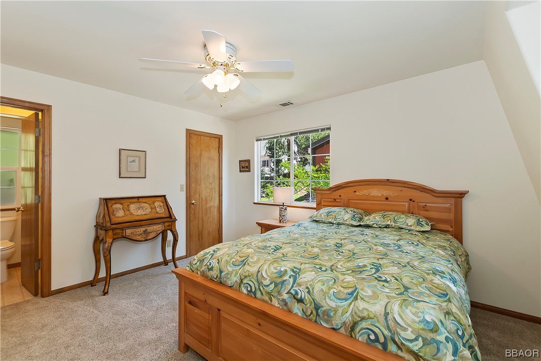 189 Pine Ridge Road Crestline, CA 92325 - Photo 18 of 30 a bedroom with a bed and a chandelier