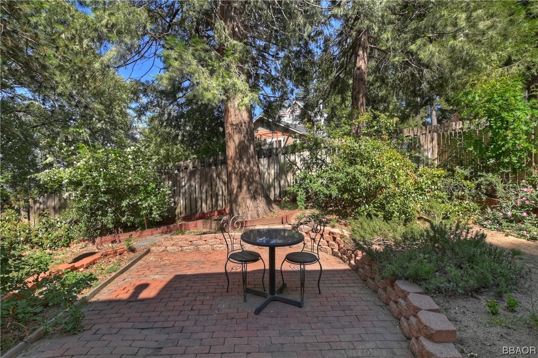 189 Pine Ridge Road Crestline, CA 92325 - Photo 21 of 30 a bench sitting in the middle of a backyard