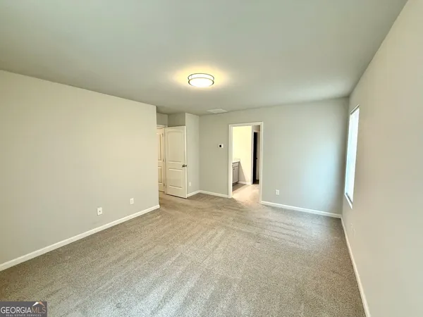 a view of an empty room and a window