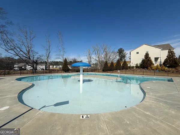 a view of a swimming pool with a yard