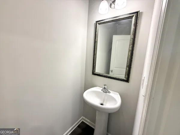 a bathroom with a sink and mirror