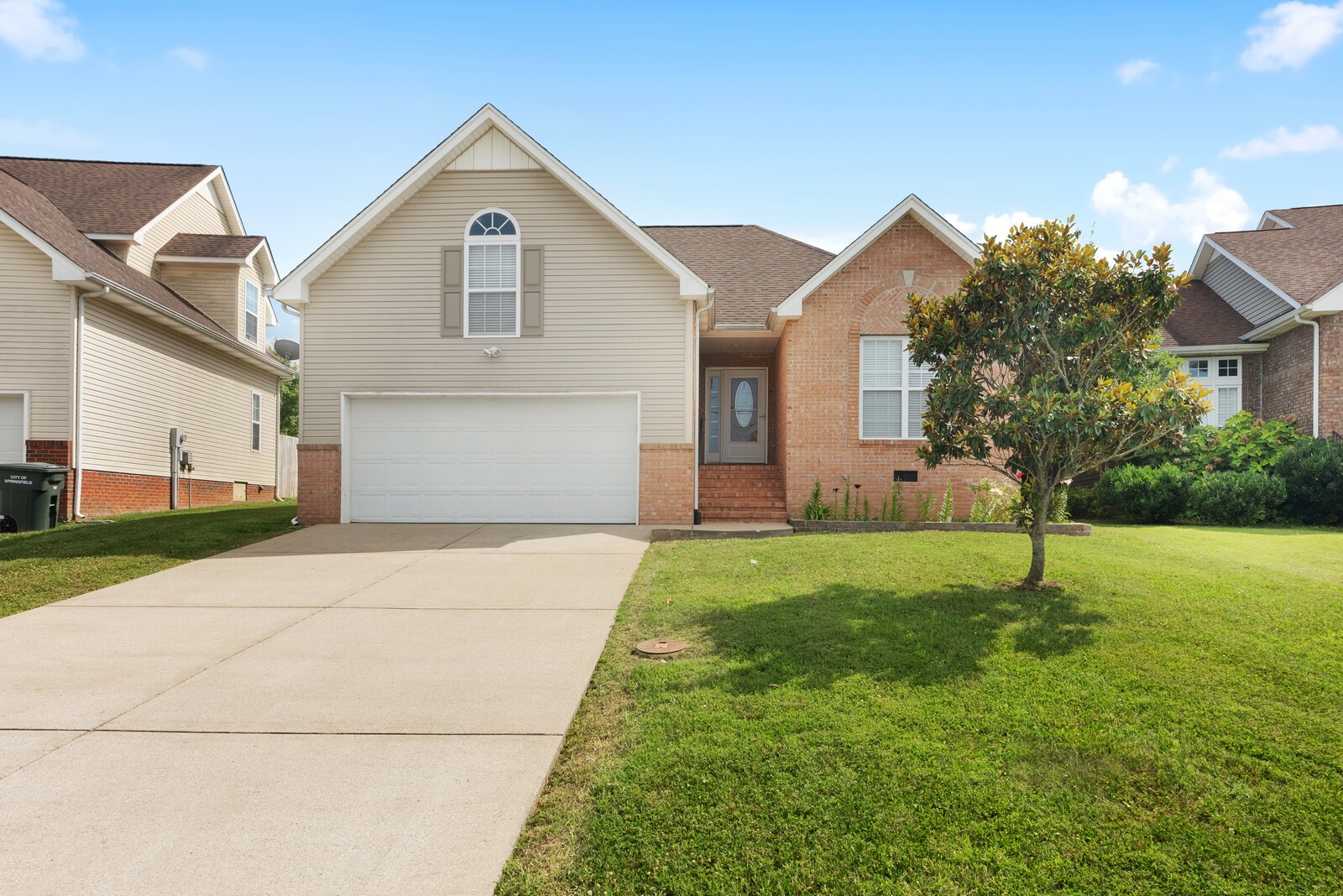 a front view of a house with a yard and garage