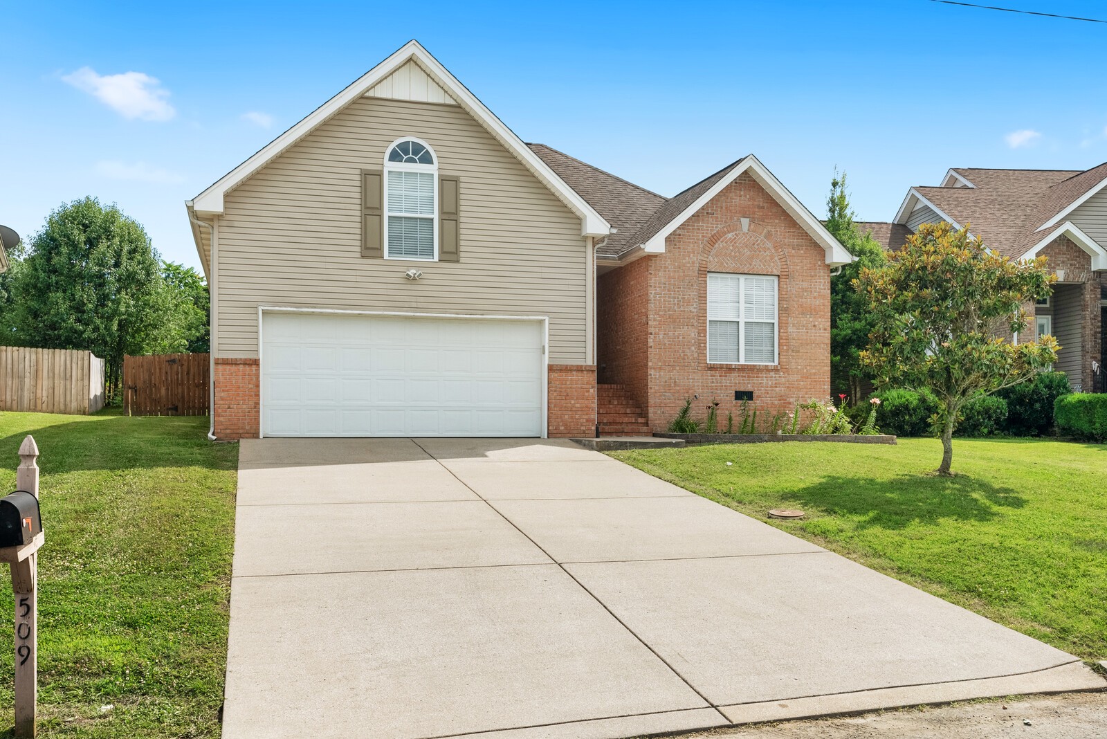 509 Berry Circle Springfield, TN 37172 - Photo 3 of 20 a front view of a house with a yard and garage
