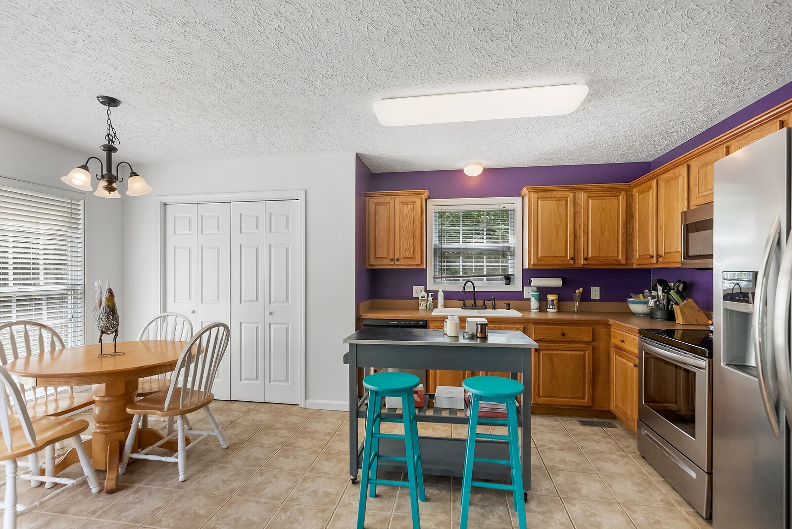 509 Berry Circle Springfield, TN 37172 - Photo 8 of 20 a kitchen with a stove a sink dishwasher a dining table and chairs with wooden floor