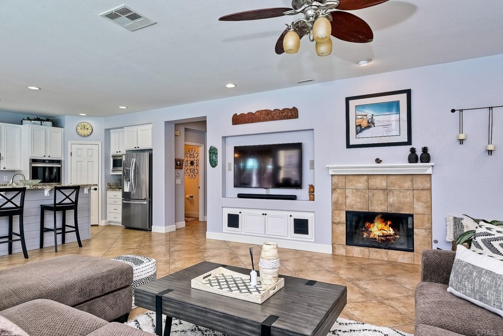 1738 Star Crest Place San Marcos, CA 92078 - Photo 13 of 51 a living room with furniture a flat screen tv and a fireplace