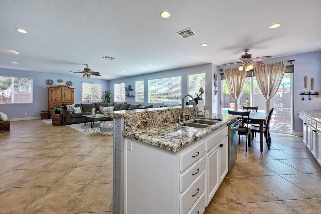 1738 Star Crest Place San Marcos, CA 92078 - Photo 22 of 51 a large kitchen with kitchen island a sink table and chairs