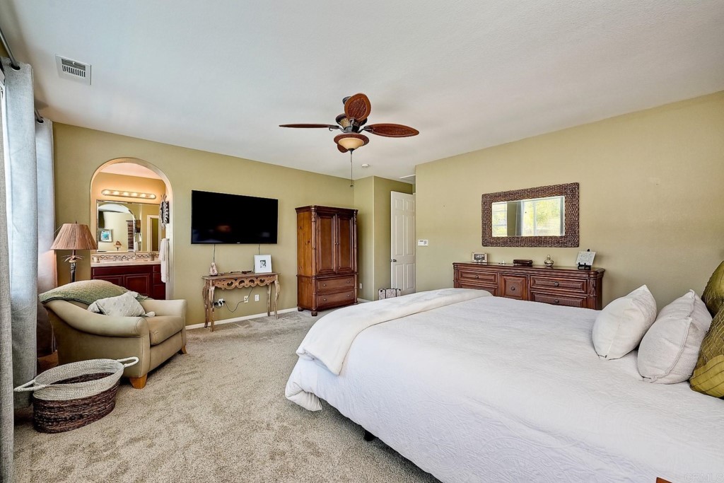 1738 Star Crest Place San Marcos, CA 92078 - Photo 28 of 51 a spacious bedroom with a bed and a flat screen tv