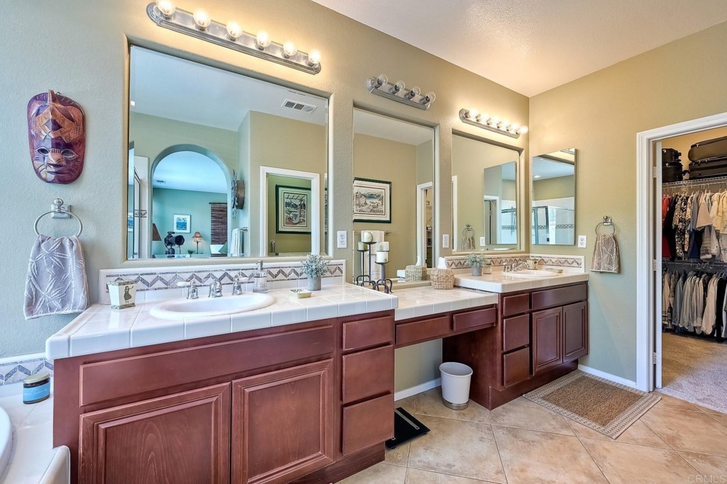 1738 Star Crest Place San Marcos, CA 92078 - Photo 29 of 51 a bathroom with a double vanity sink and a mirror