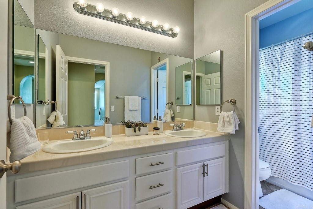 1738 Star Crest Place San Marcos, CA 92078 - Photo 36 of 51 a bathroom with a double vanity sink and a mirror