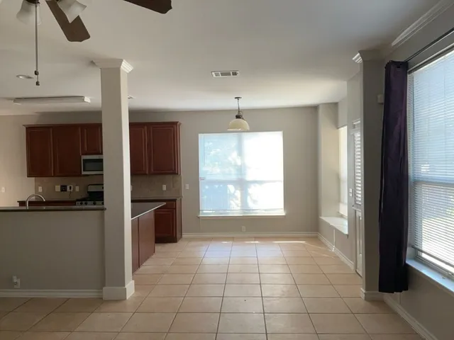 a kitchen with a sink and a stove top oven with granite countertops