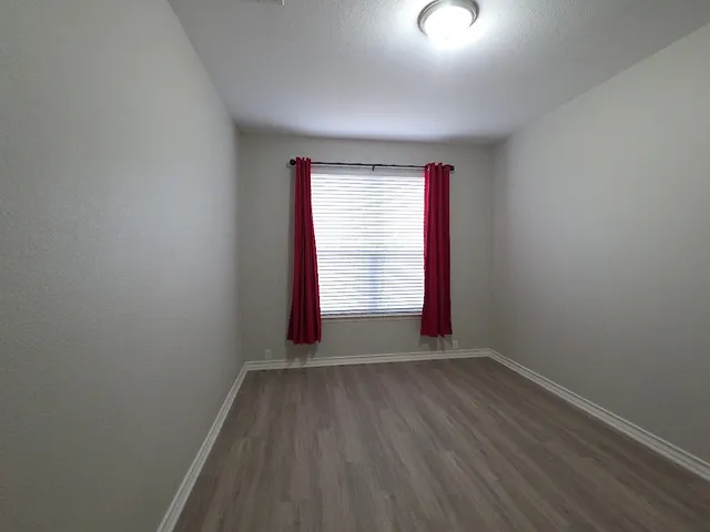 a bathroom with a sink a toilet and a window