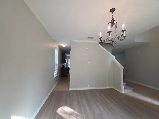 a view of a room with wooden floor