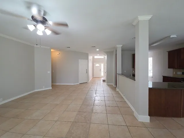 a view of a kitchen with a sink and a chandelier fan