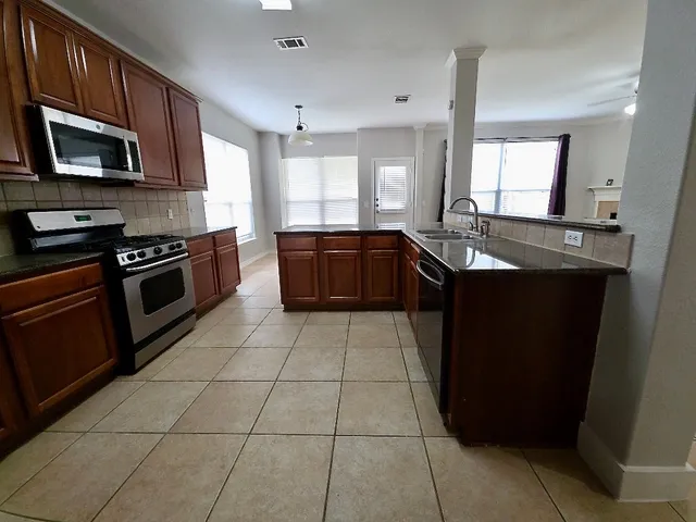 a view of a kitchen with microwave and cabinets