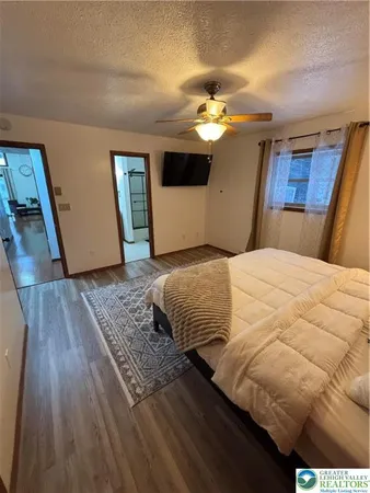 a bedroom with a large bed and a chandelier