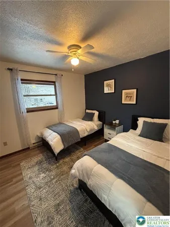 a bedroom with two beds and a chandelier