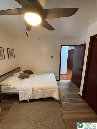 a bedroom with a bed and a mirror
