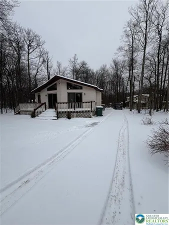 a wooden bench sitting in middle of snow