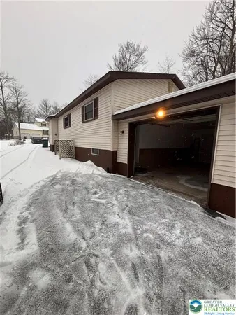 a view of house with yard and garage