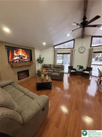 a living room with furniture flat screen tv and a fireplace