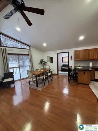 a living room with furniture and kitchen view