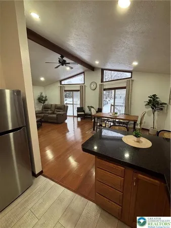 a kitchen with sink refrigerator and cabinets