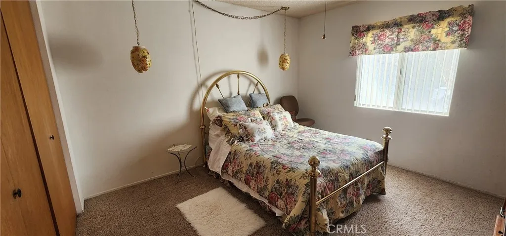 12491 Toby Lane Blythe, CA 92225 - Photo 16 of 45 a bed sitting in a bedroom next to a window