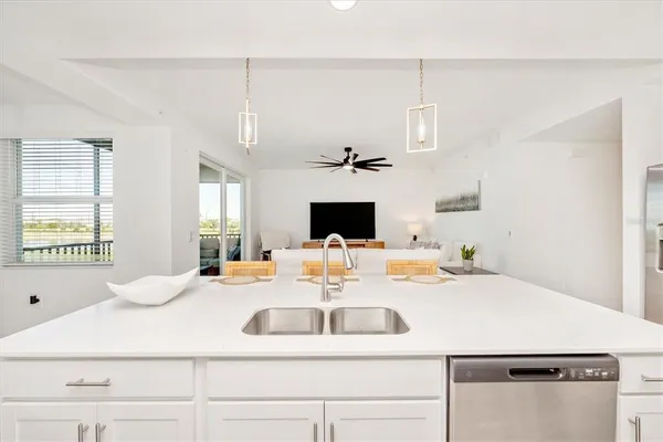 a living room with furniture and a view of kitchen