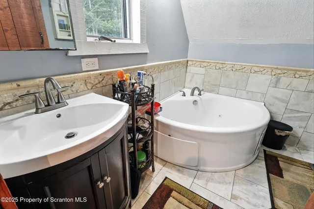 a bathroom with a sink a window and a mirror