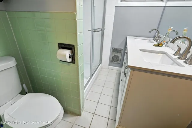 a view of a house with a big yard and large trees