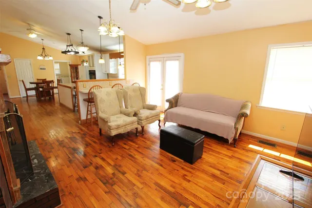 a living room with furniture and a chandelier
