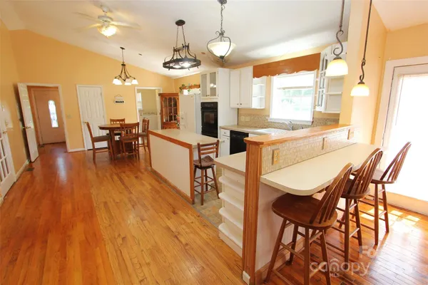 a view of a dining room with furniture and wooden floor