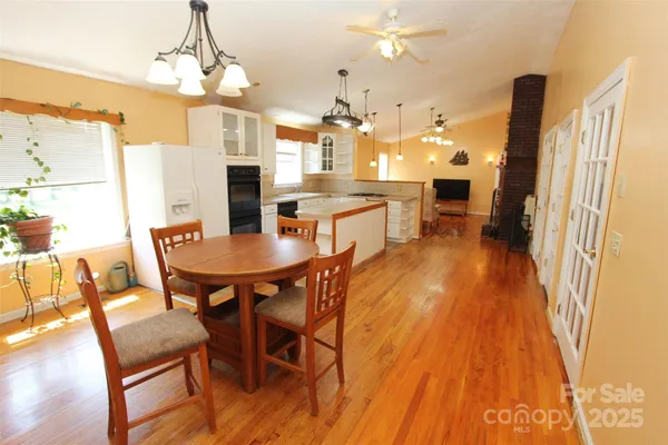a dining room with stainless steel appliances kitchen island granite countertop furniture and a kitchen view