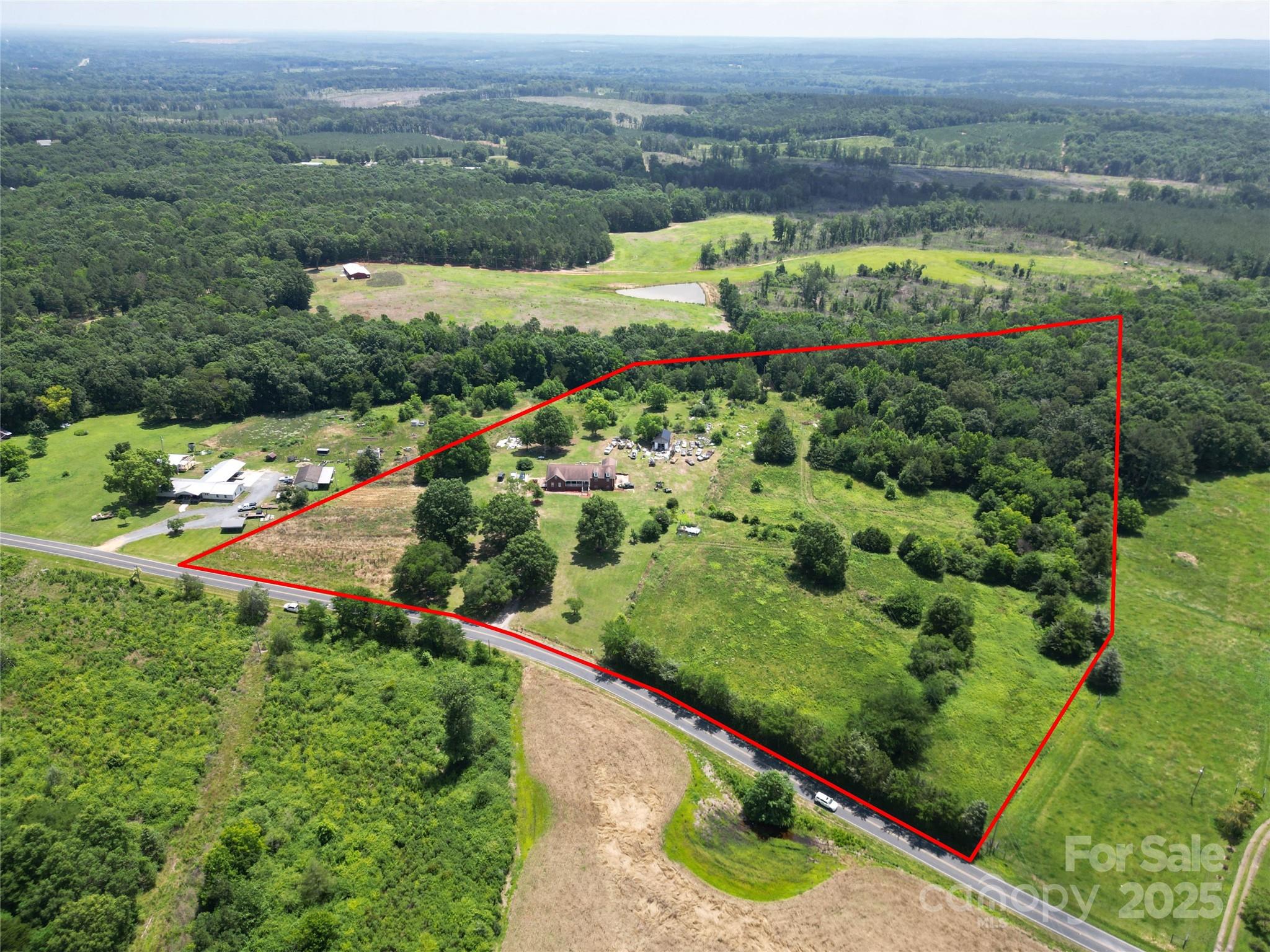 843 Upper White Store Road Peachland, NC 28133 - Photo 2 of 48 an aerial view of green landscape with trees houses and mountain view