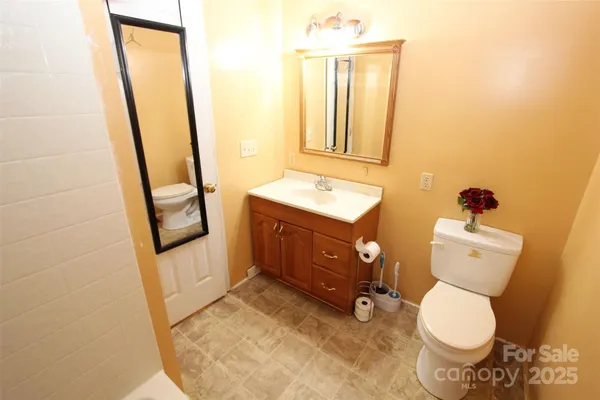 a bathroom with a toilet sink and mirror