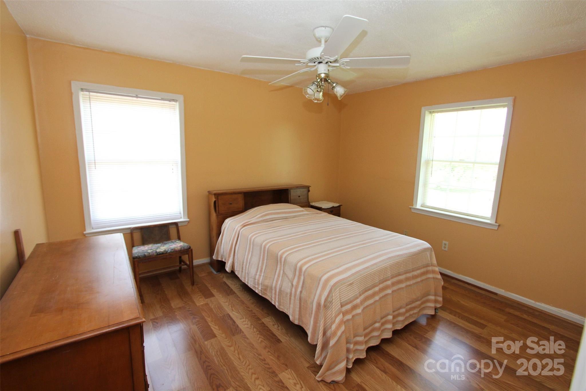 843 Upper White Store Road Peachland, NC 28133 - Photo 24 of 48 a bedroom with a bed and wooden floor