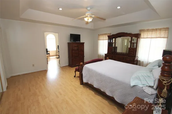 a bedroom with a bed and a television