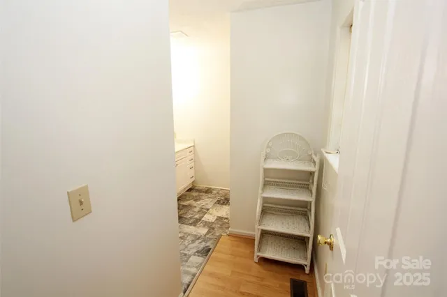 a view of walk in closet with empty racks