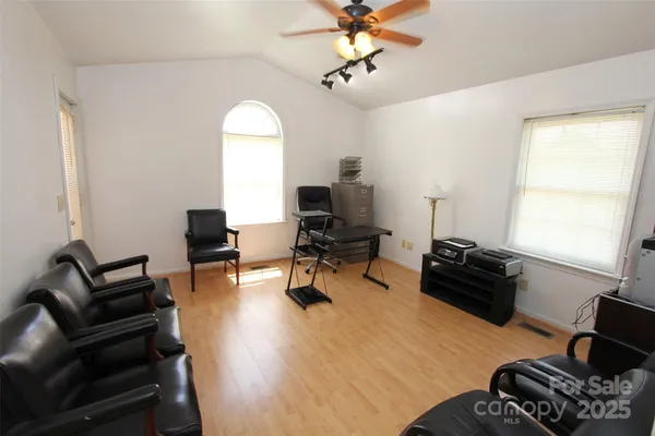 a view of a livingroom with workspace and a couch