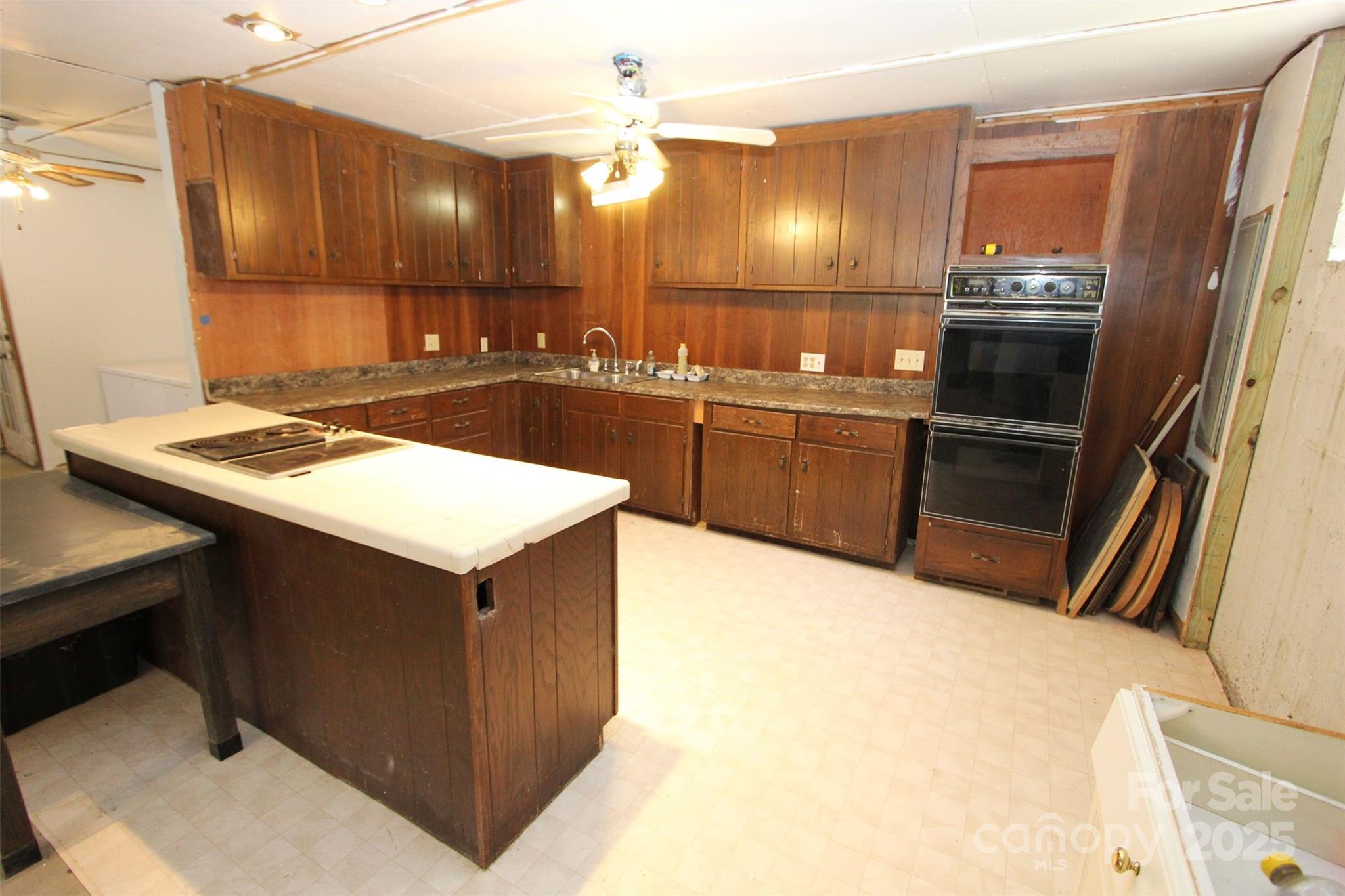 843 Upper White Store Road Peachland, NC 28133 - Photo 36 of 48 a kitchen with a sink refrigerator and stove
