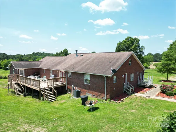 a aerial view of a house with a garden and deck