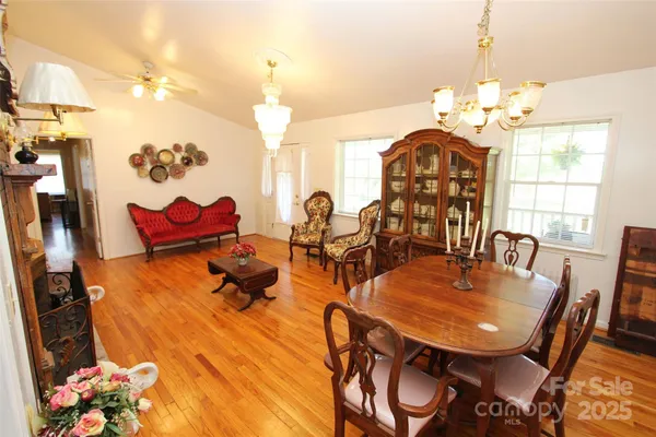 a view of a dining room with furniture and chandelier