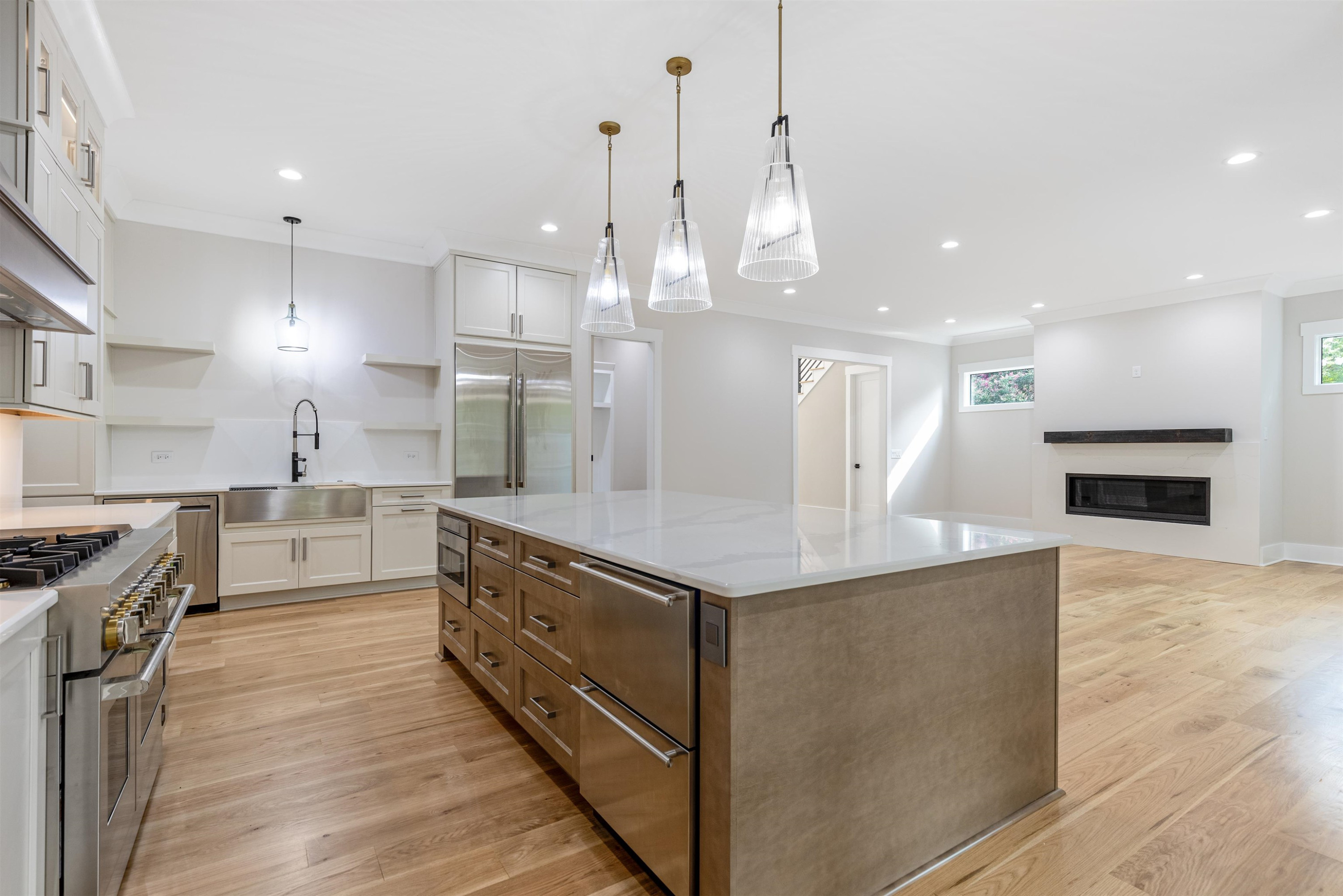 336 Waldo Street Cary, NC 27511 - Photo 12 of 62 a large kitchen with kitchen island a stove a sink a center island and wooden floor