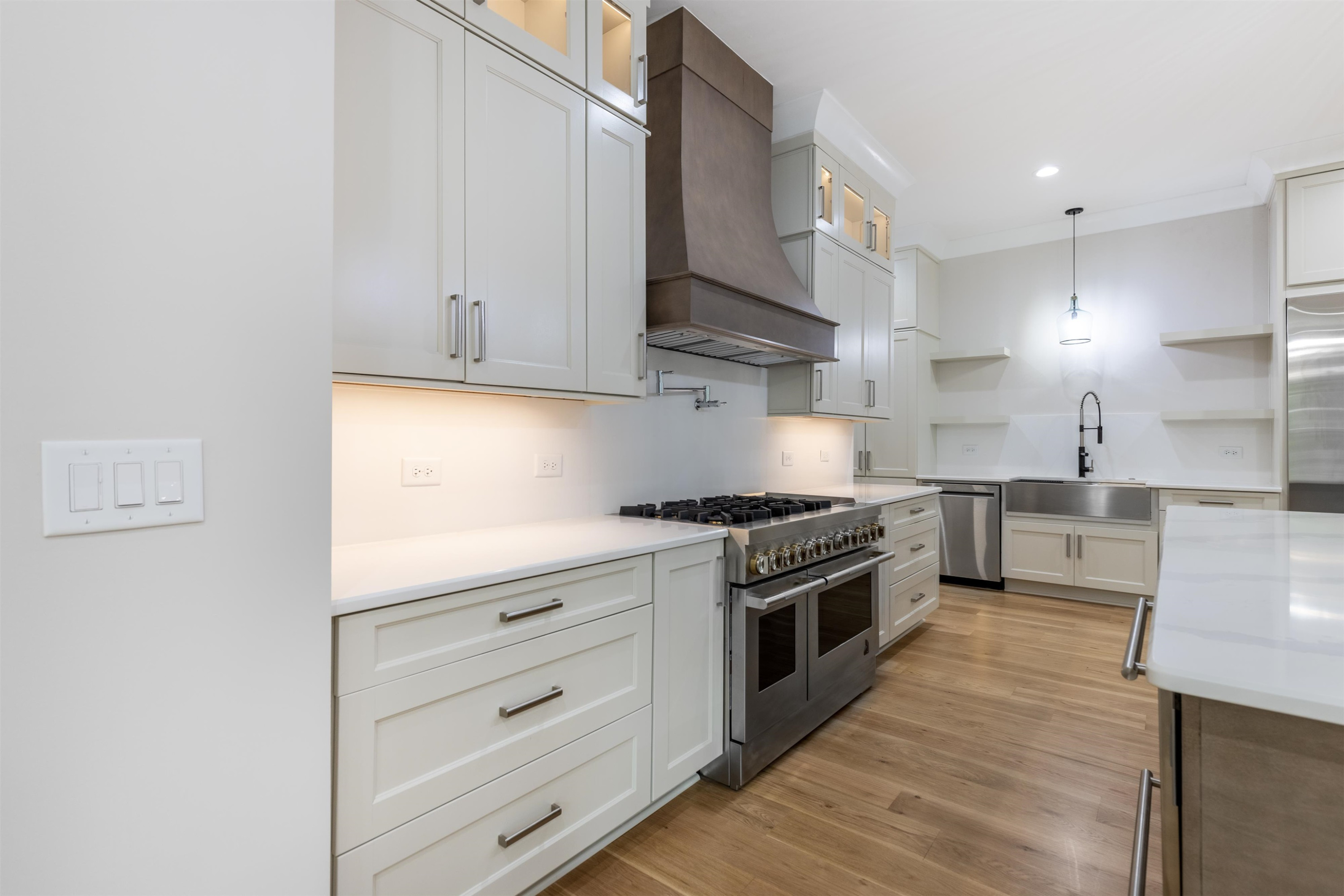 336 Waldo Street Cary, NC 27511 - Photo 14 of 62 a kitchen with stainless steel appliances granite countertop a stove a sink and white cabinets