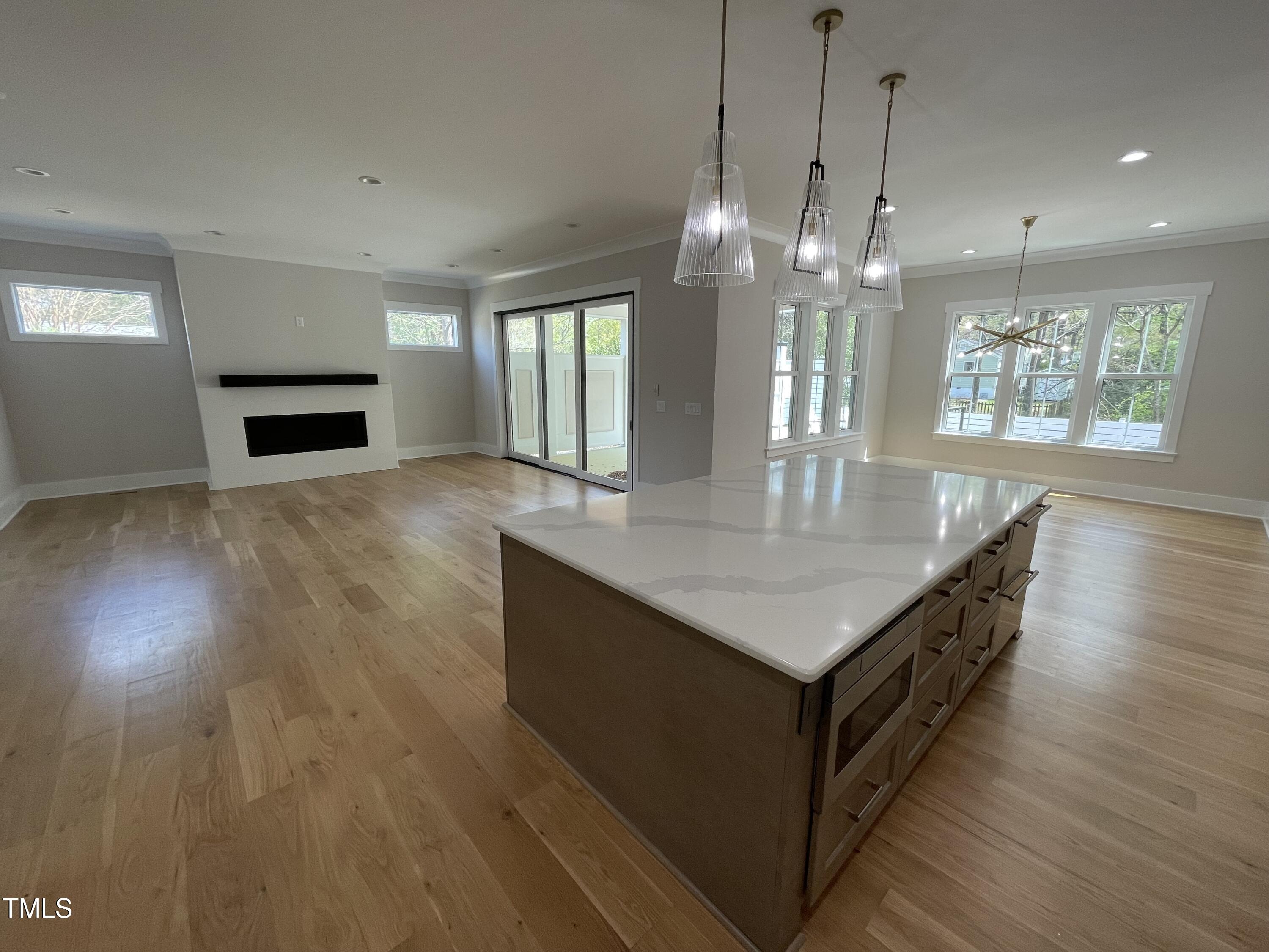 336 Waldo Street Cary, NC 27511 - Photo 16 of 62 a kitchen with counter top space and wooden floor