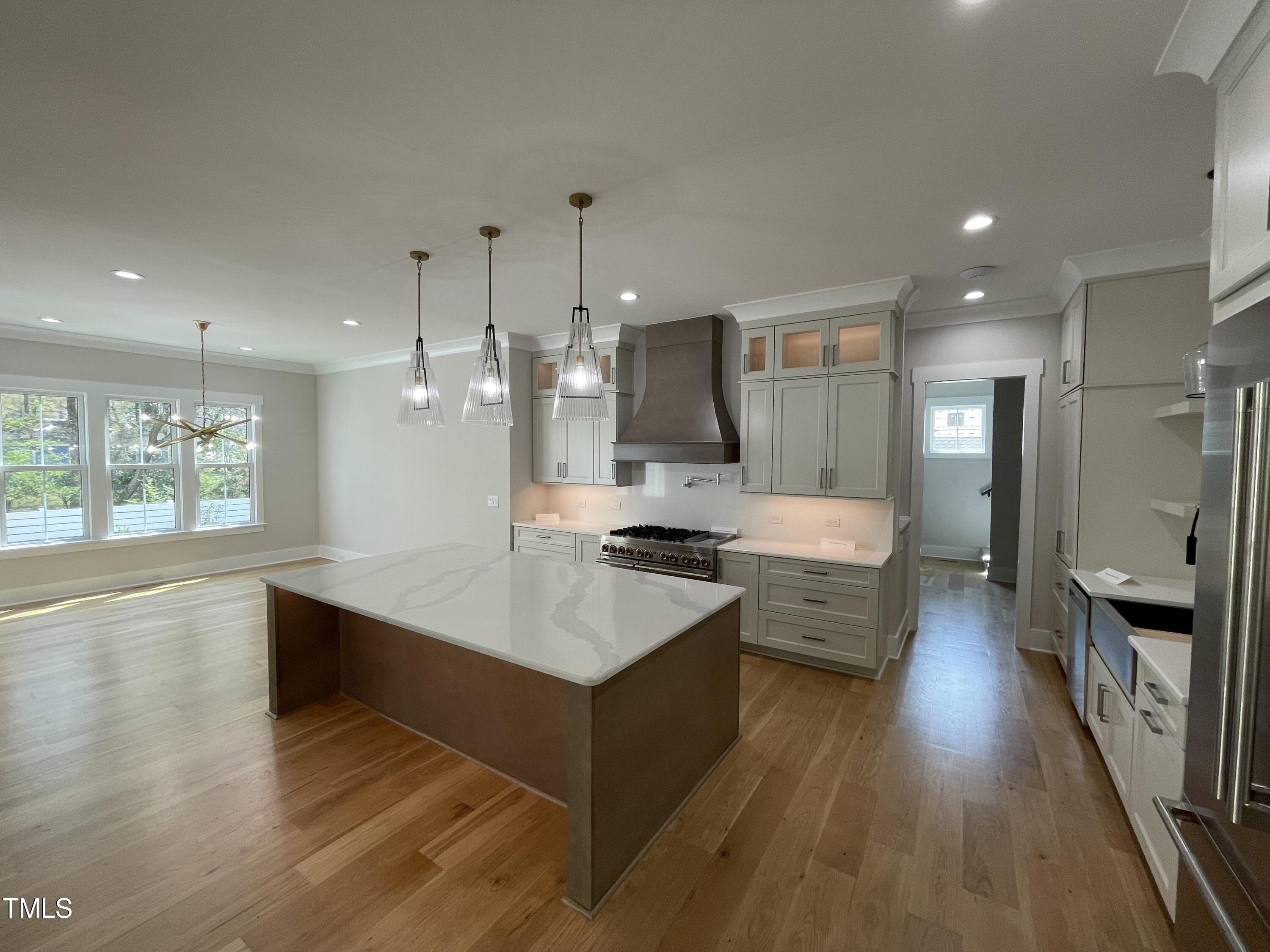 336 Waldo Street Cary, NC 27511 - Photo 17 of 62 a large kitchen with a counter space a sink stainless steel appliances and cabinets