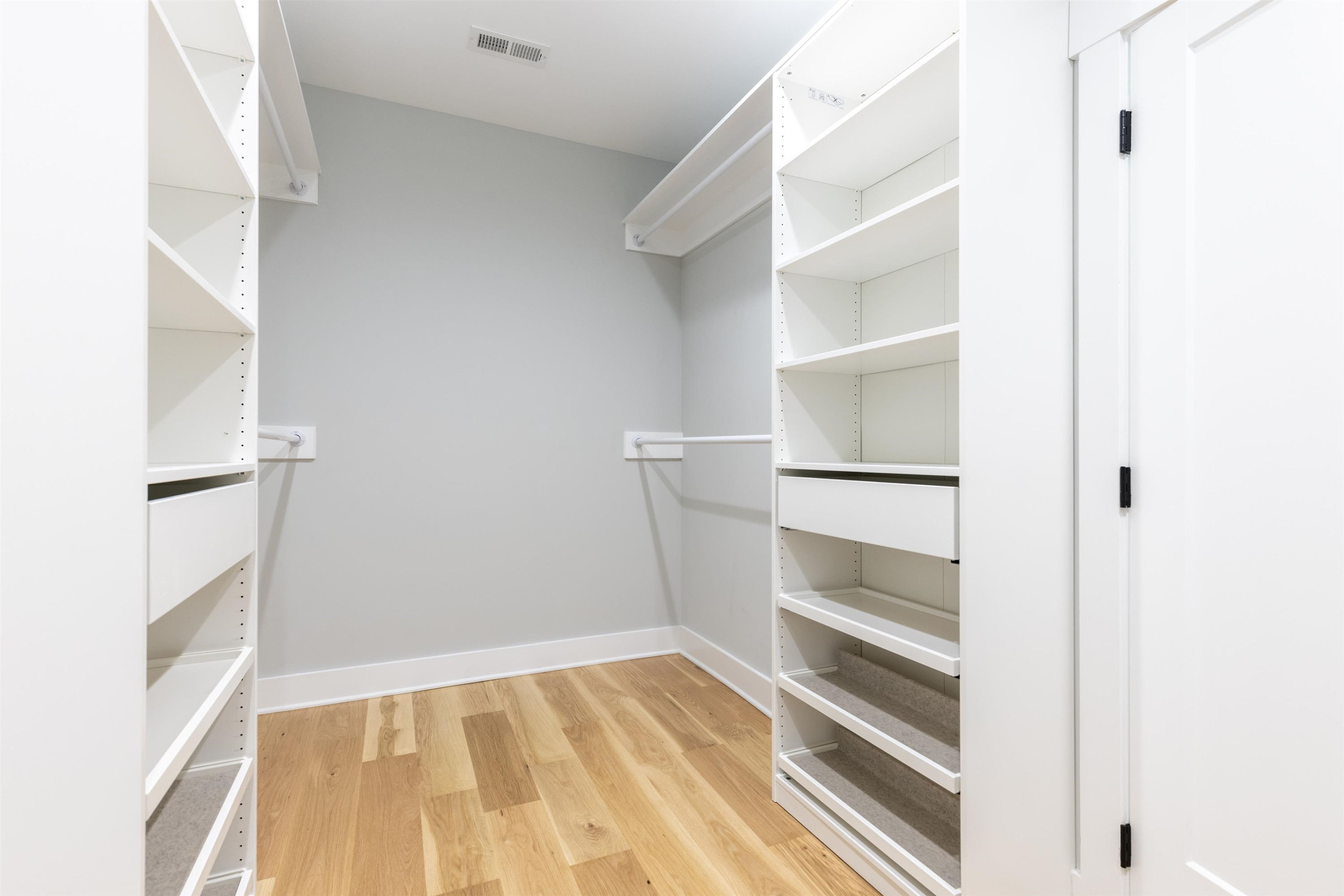336 Waldo Street Cary, NC 27511 - Photo 28 of 62 a view of walk in closet with empty racks
